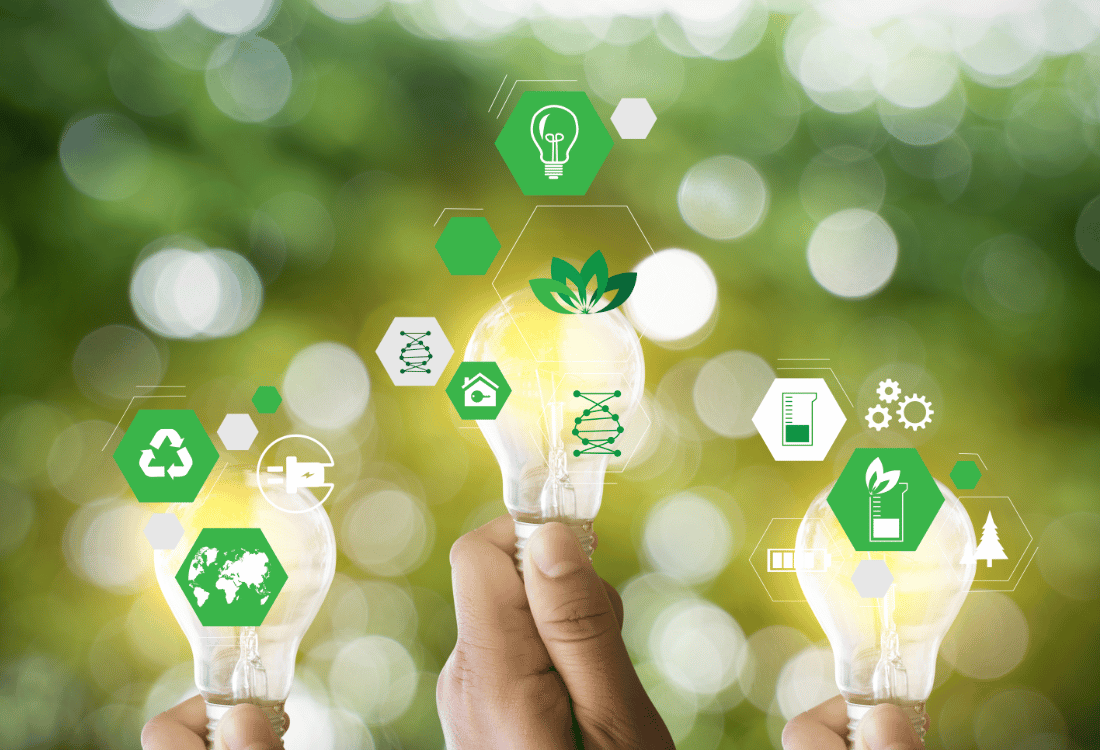 Hands holding light bulbs with green icons representing sustainability, innovation, and eco-friendly practices, symbolises the challenges involved in achieving sustainable procurement. 