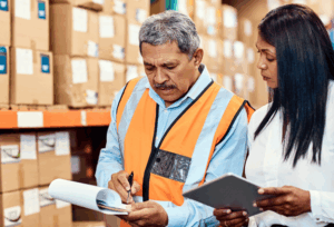 A manager checks the quality and quantity of the inventory brought by the supplier before determining whether they are overstocking or if more stock should be ordered. 
